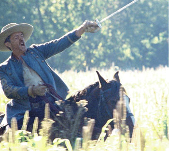 Nat on a horse holding a saber aloft